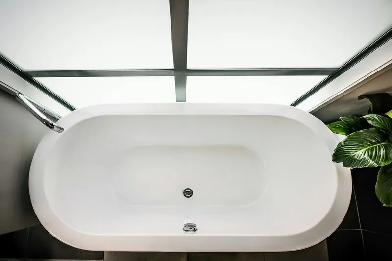 Freestanding soaking tub by a bright window
