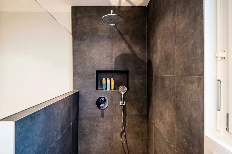 Remodeled white subway tile shower with bench