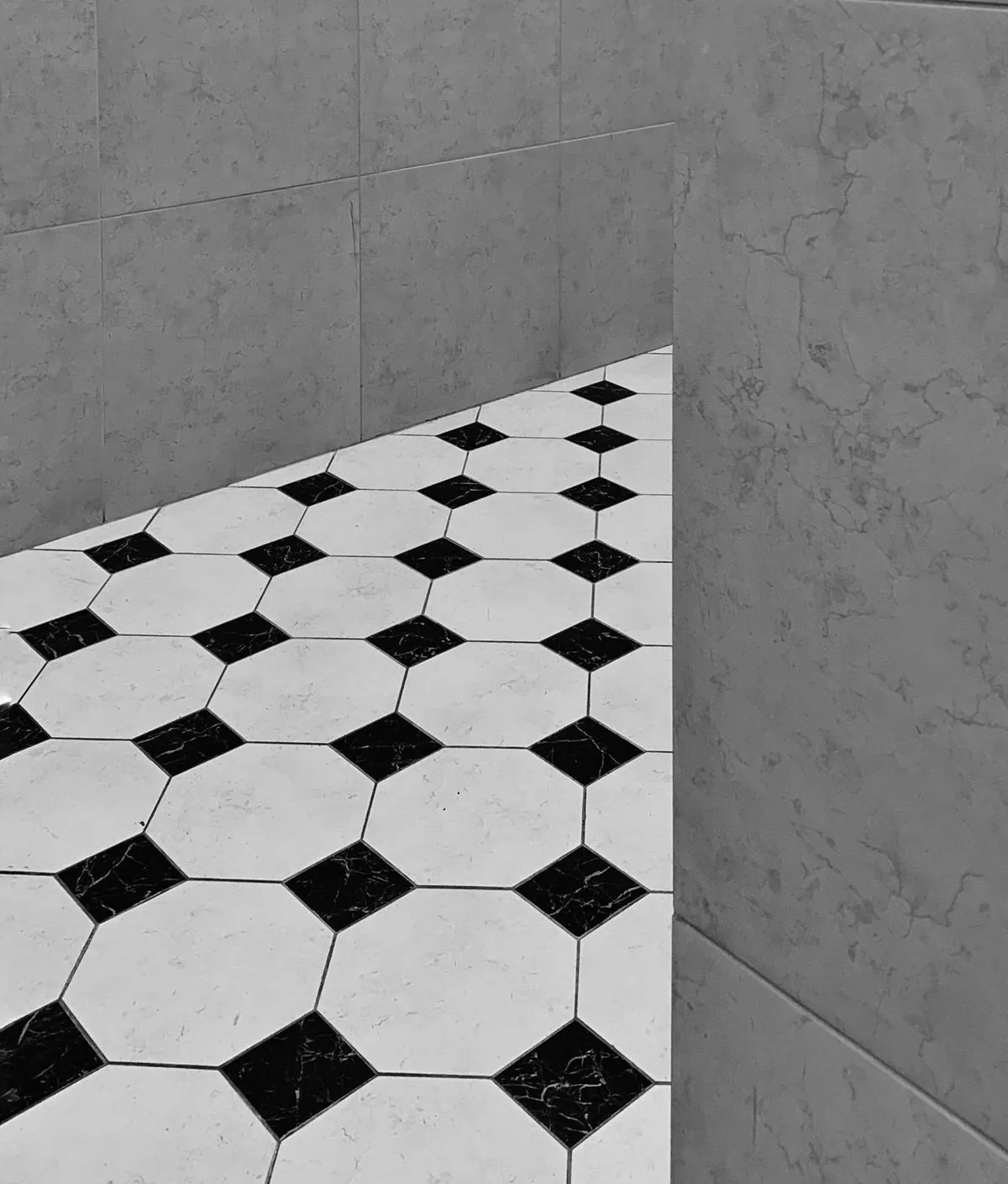 Black and white hexagonal tile pattern on a bathroom floor.