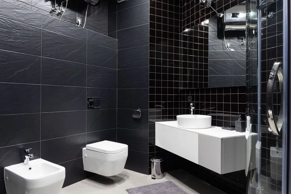 Bathroom interior decorated with polished black tile.