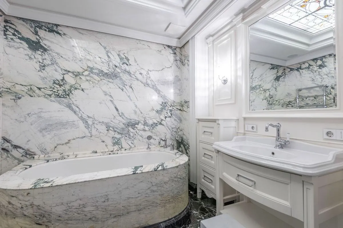 Luxurious bathroom with marble walls and modern fixtures.