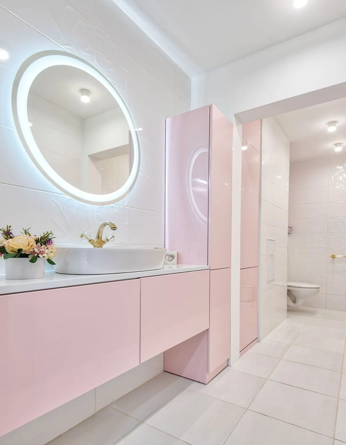 Modern bathroom interior with a glowing mirror and clean contemporary lines.