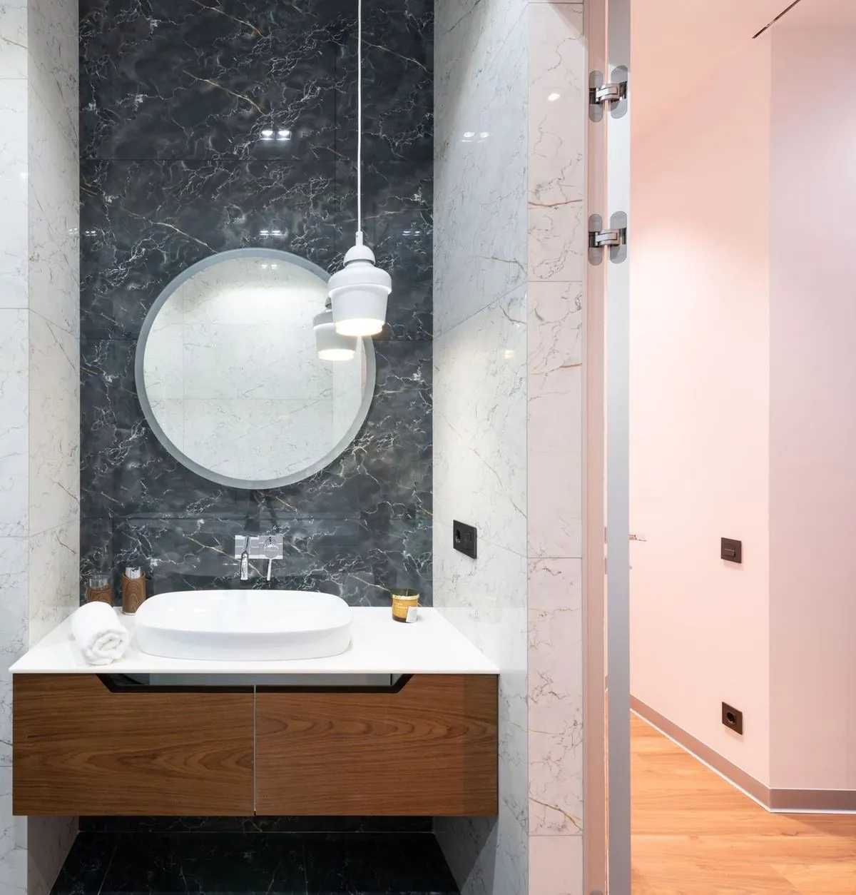 Contemporary light bathroom interior with a mirror and sink.