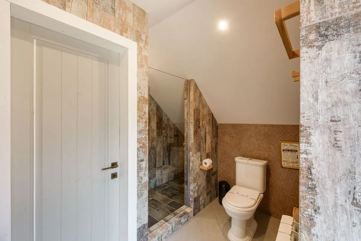 Chic rustic bathroom with a glass-door shower.