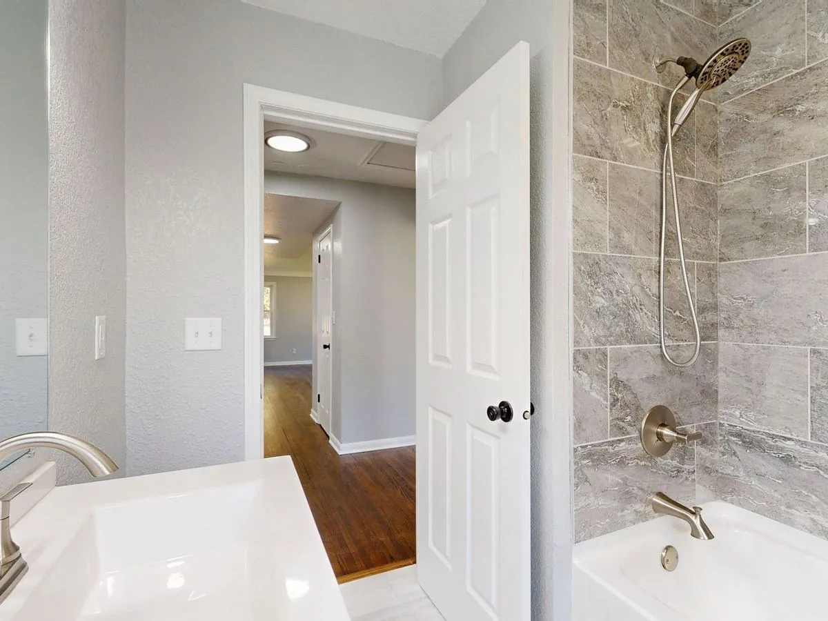 Contemporary bathroom with grey tile shower and sleek modern fixtures