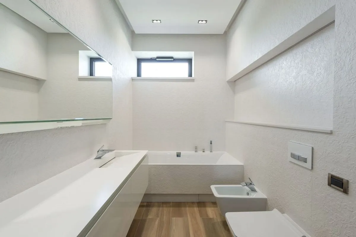 Modern bathroom interior with white walls, furniture, and clean design