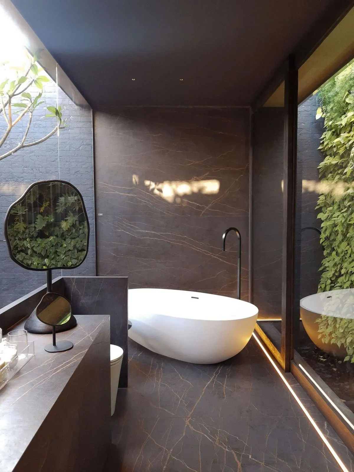Elegant freestanding tub in a marble bathroom with natural light