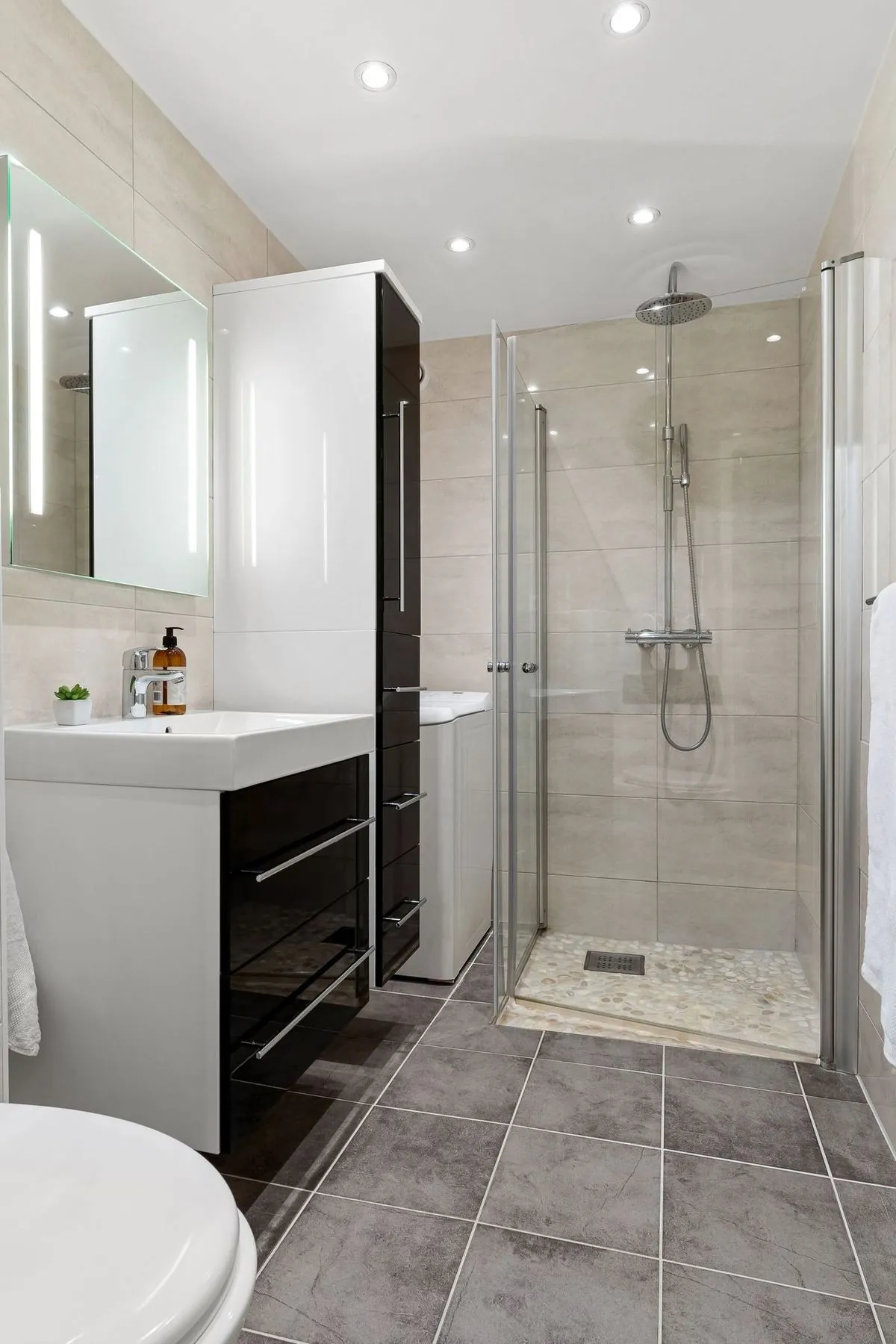 Contemporary bathroom interior featuring a sleek glass shower and elegant fixtures