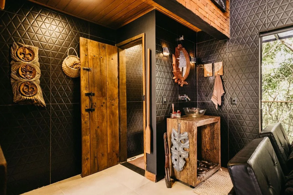 Cozy rustic bathroom interior with wooden elements and warm-toned decor.