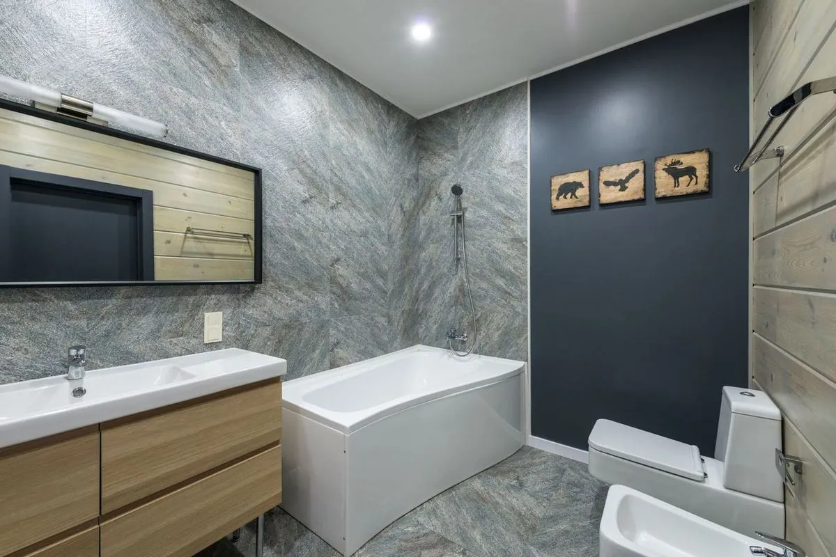 Interior of bathroom with mirror above sink.