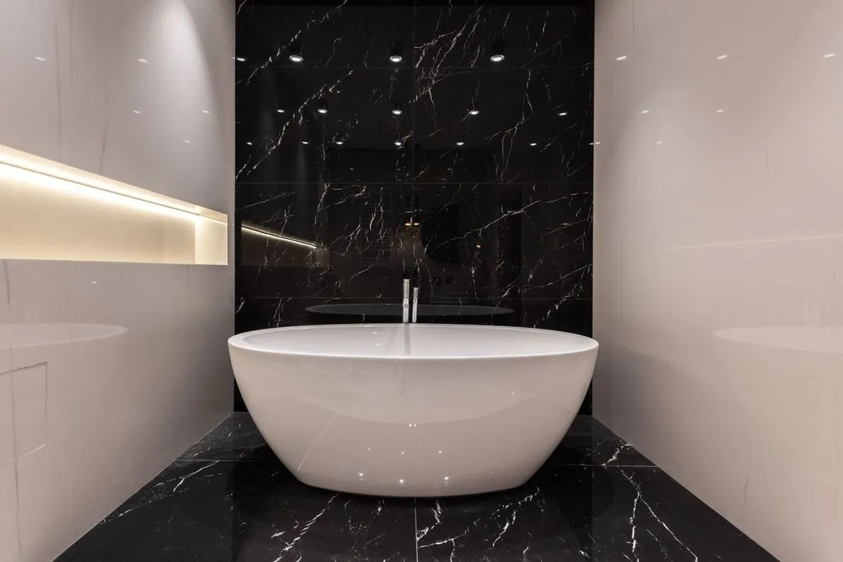 Elegant bathroom featuring a sleek marble bathtub in a contemporary setting